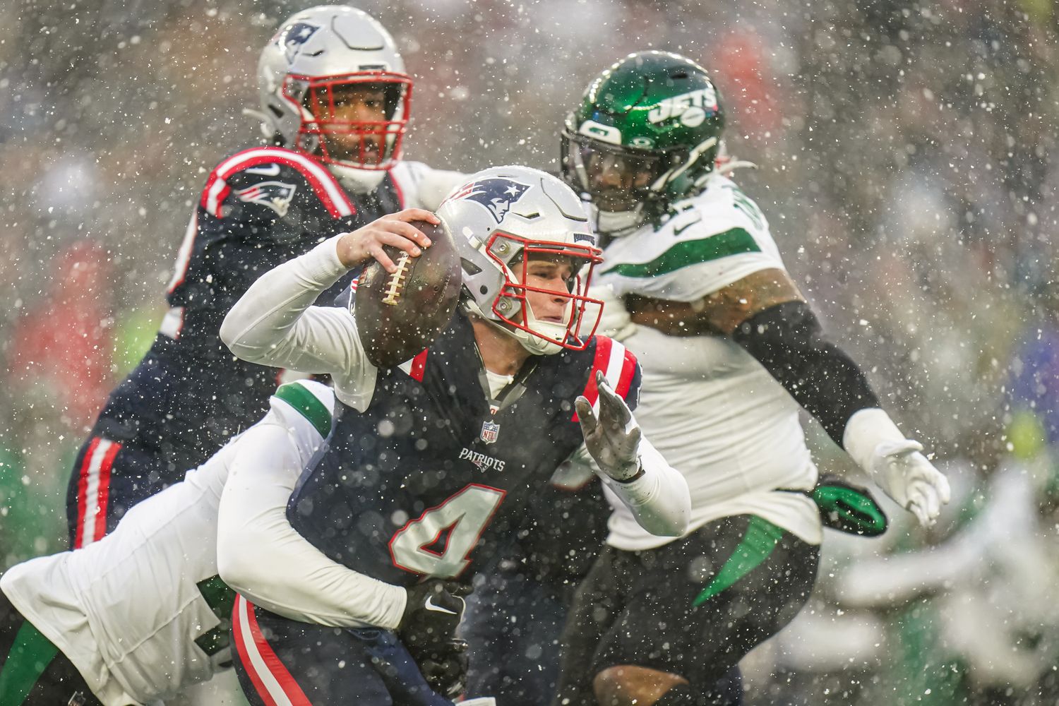New England Patriots quarterback Bailey Zappe (4) is sacked by New York Jets linebacker Bryce Huff (47) in the first half at Gillette Stadium.